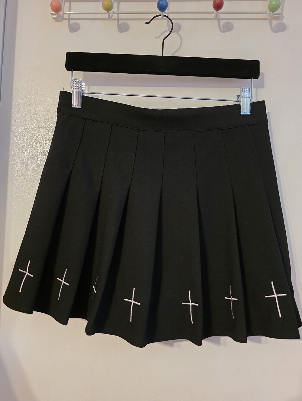 Black Pleated Skort With White Cross Details.